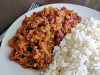 Chilli con carne with rice on a plate.  Traditional Italian food. 
