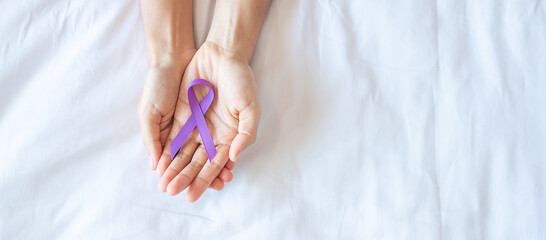 Pancreatic Cancer, world Alzheimer, epilepsy, lupus and domestic violence day Awareness month, Woman holding purple Ribbon for supporting people living. Healthcare and World cancer day concept - obrazy, fototapety, plakaty