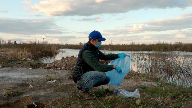Ivanovo, Russia, April 26, 2021, Editorial, man collects plastic bottles, the concept of ecology of the earth, protection of the planet from garbage