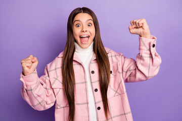 Portrait of attractive lucky satisfied cheerful girl wearing checked coat rejoicing isolated over bright violet purple color background