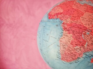 detail of revolving world map on pink background