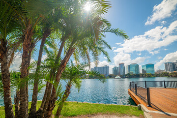 Sun shining over beautiful Lake Eola park in Orlando - obrazy, fototapety, plakaty