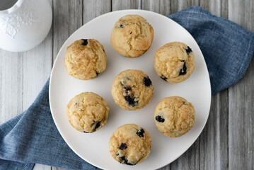 Overhead view of a plate of freshly baked gluten-free dairy-free blueberry muffins.