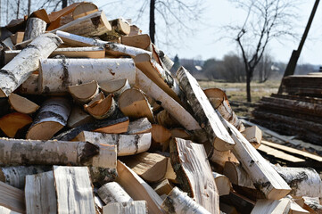 Stocks of birch firewood. Harvesting firewood for the winter