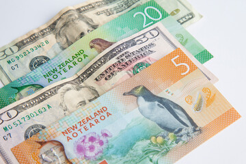 US dollar and New Zealand dollar on white background, foreign exchange	