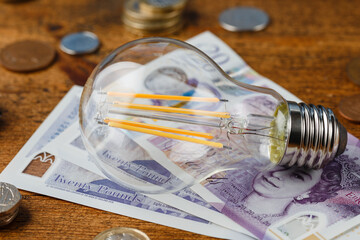 stylish energy efficient led filament Lightbulb on sterling pounds money saving concept United...