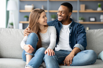 Portrait Of Loving Interracial Couple Relaxing Together At Home