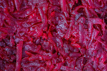Grated fried red beetroot for salad, close up. Beetroot slice background or texture
