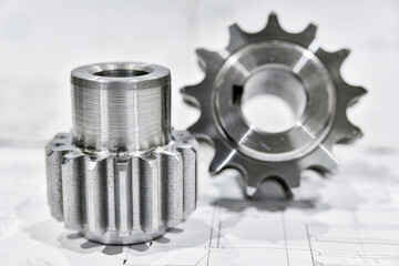 A cogwheel made on a gear cutting machine lies on the technical