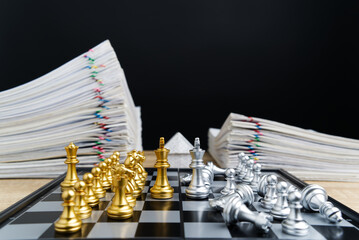Golden king confront silver king have blur silver chess falling down between overload report of...