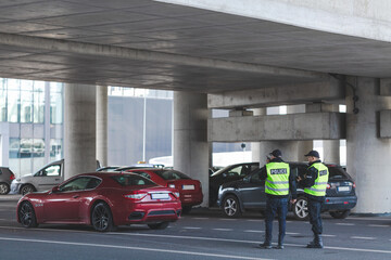 Two police officers during patrol on the parking lot © Photographee.eu