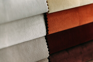 Collection of colorful velour textile samples. Fabric designed for sofas and armchairs. Fabric texture background