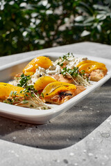 Bruschetta with peach, cottage cheese and blue cheese on a stone texture. Italian cuisine.