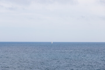 Small white boat in the middle of the sea. Landscape of the mediterranean sea