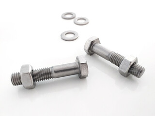 Aerial view of bolts with nut and metal washers in horizontal position isolated on white background. Close up of Piece of hardware store. DIY utensils and tools.