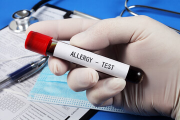 Allergy  test , vacuum tube with blood in the doctor's hand, selective focus, close-up.