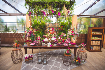 cake table decorated with flowers for wedding