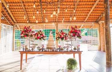cake table decorated with flowers for wedding