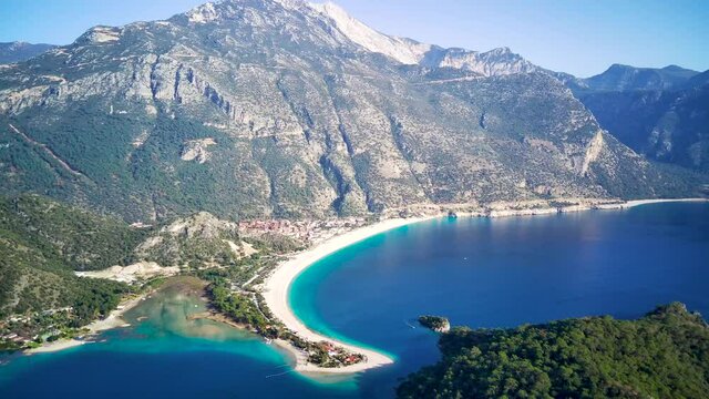 Amazing high angle top drone view on world famous paragliding and parasailing turkish spot for extrim parachute sport in Oludeniz in Fethiye, Turkey
