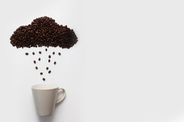 
a creative image of a cloud and raindrops made from coffee beans and a white cup without a...