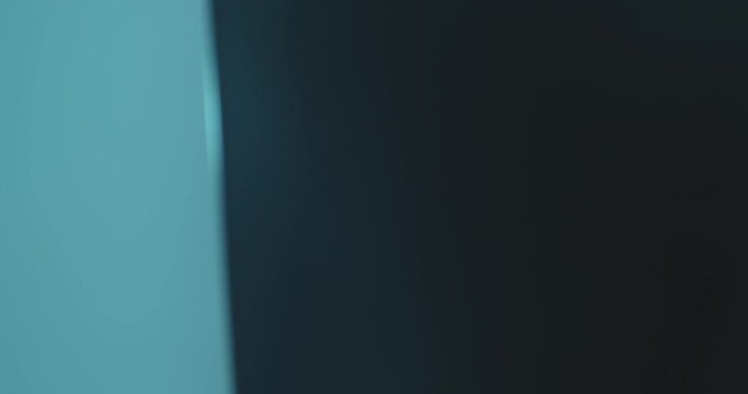 Close-up face of a female patient who is standing inside of Cephalometric X-ray unit while having a scanning of her head.