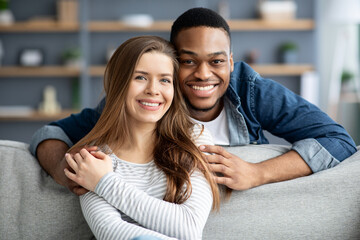 Portrait Of Romantic Interracial Couple Posing Together At Home