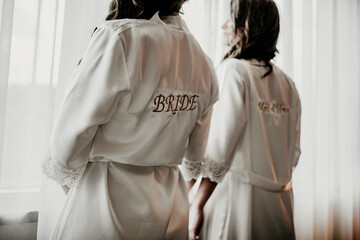 wedding details for bride and maid of honor pink and white bathrobes preparations	