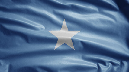 Somalian flag waving in the wind. Close up of Somali banner blowing soft silk.