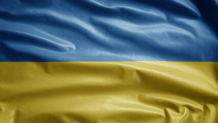 Ukrainian flag waving in the wind. Close up of Ukraine banner blowing soft silk.