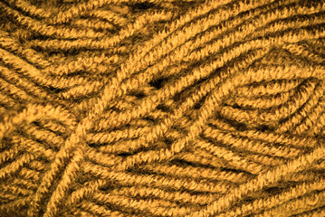Macroscopic photo of brown ropes woven into a tight ball