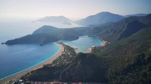 Amazing high angle top drone view on world famous paragliding and parasailing turkish spot for extrim parachute sport in Oludeniz in Fethiye, Turkey
