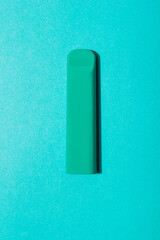 Colorful disposable electronic cigarette pod on a blue background. alternative to modern smoking, vaping and nicotine. tobacco substitution green