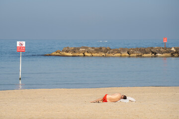 A Man Sunbathing on a Beach