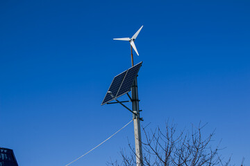 Household home turbine on a clear day. With these generators, households save energy costs.