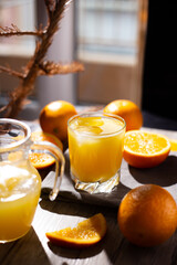 table full of fresh oranges and juice in springtime