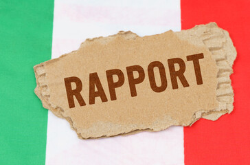 Against the background of the flag of Italy lies cardboard with the inscription - rapport
