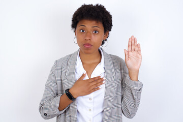 African American businesswoman with curly bushy hair wears  formal clothes over white background...