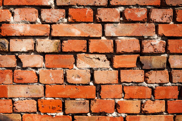 Old red brick wall. Cracked bricks.