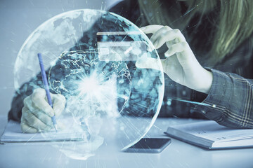 Multi exposure of woman on-line shopping holding a credit card and financial theme drawing. Business E-commerce concept.