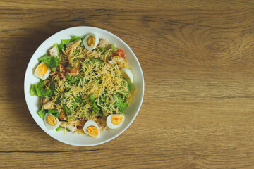 light diet salad in a plate on a wooden background