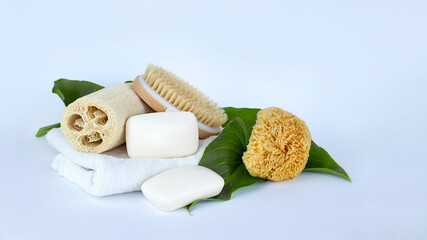 Soap bars, white towel, natural brush and sponges. Spa, body and beauty care concept.