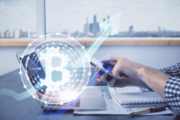 Double exposure of man's hands holding and using a phone and crypto currency blockchain theme drawing.