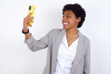 African American businesswoman with curly bushy hair wears  formal clothes over white background...