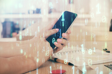 Double exposure of man's hand holding and using a digital device and data theme drawing. Technology concept.