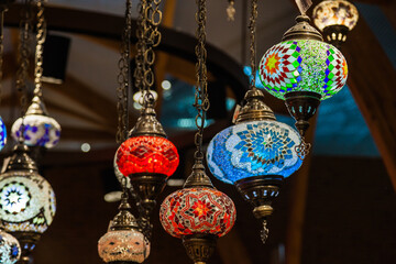 Turkish luminous chandeliers hanging from the ceiling in the Istanbul Bazaar.