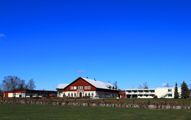 Nice landscape photo with red and white buildings. Great green lawn and a clear blue sky. No clouds. Outside a sunny spring day. Skokloster, Håbo, Uppsala, Sweden, Europe.