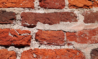 Brick wall with red bricks. Old style.  Uneven gray seams. Close up and isolated. Copy space for text.