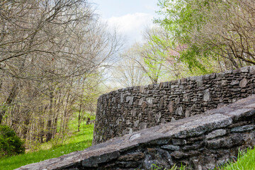 A field stone wall and ramp in the woods on the Natchez Trace Parkway.