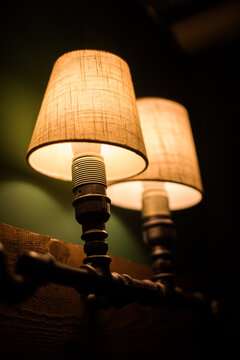 Color image of a lit up vintage wall lamp.