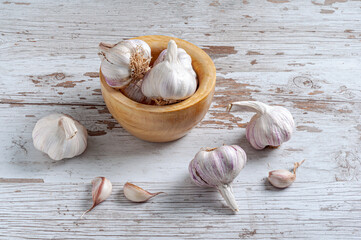 garlic heads in a wooden mortar